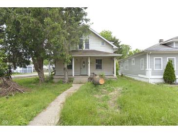 Quaint two-story home featuring a covered front porch and a mature tree in the front yard at 364 S Cole St, Indianapolis, IN 46241