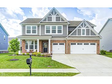 Beautiful two-story home featuring a brick facade, gray siding, a well-manicured lawn, and a two car garage at 3667 Gilmore Pl, Bargersville, IN 46106