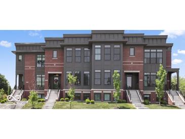 Stunning townhouse with brick and modern siding, steps and manicured landscaping at 420 Monon Wy Dr, Carmel, IN 46032
