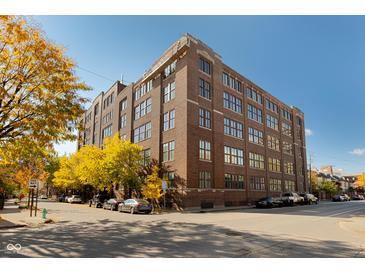 Beautiful brick building with large windows and street view on a sunny day at 430 N Park Ave # 211, Indianapolis, IN 46202