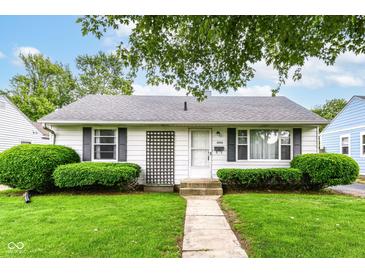 Charming single-story home featuring a well-maintained lawn and manicured shrubs at 4751 Payton Ave, Lawrence, IN 46226