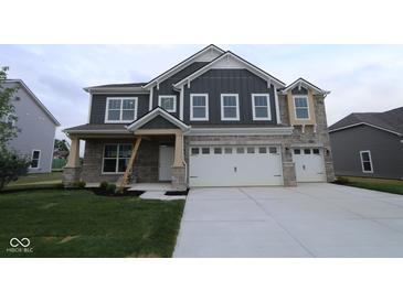 Charming home with stone accents, a large garage, and manicured lawn for curb appeal and outdoor enjoyment at 4947 Amber Crest Dr, Brownsburg, IN 46112