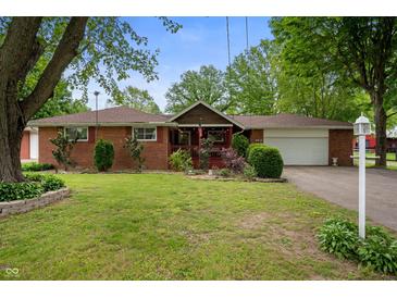 Charming red brick ranch-style home with manicured lawn and attached garage at 5092 S 50 W, Anderson, IN 46013