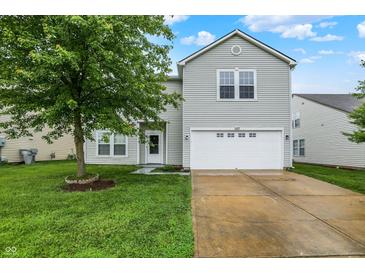 Charming two-story home with well-maintained lawn and a two car garage at 630 Harmony Way, Greenwood, IN 46143