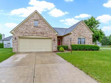 Charming brick home with a two-car garage and well-manicured lawn in a suburban neighborhood at 8599 Lansdowne Dr, Fishers, IN 46038