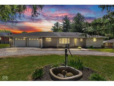 Charming one-story home with stone facade, two-car garage, and well-maintained front yard at 132 S First St, Jamestown, IN 46147