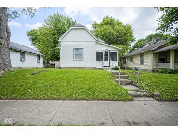 Charming home with a lush green lawn and inviting front entrance with concrete steps at 2012 George St, Anderson, IN 46016