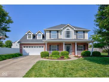 Charming two-story brick home with a well-maintained lawn and attached two-car garage at 2234 Burgundy Way, Plainfield, IN 46168