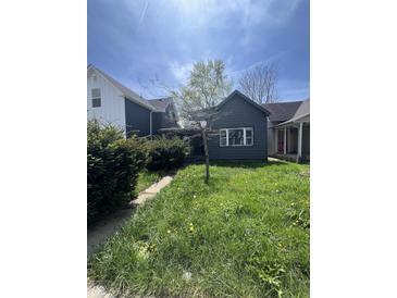 Charming single-Gathering home with a walkway and a cozy, welcoming front yard at 409 Parkway Ave, Indianapolis, IN 46225