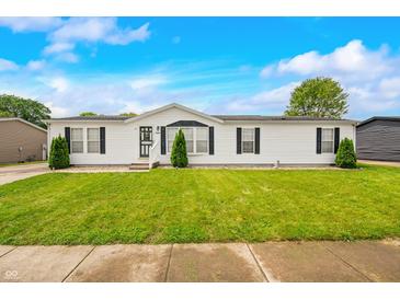 Charming single-story home with a well-manicured lawn and classic white siding at 4640 Autumn Ridge Dr, Columbus, IN 47203