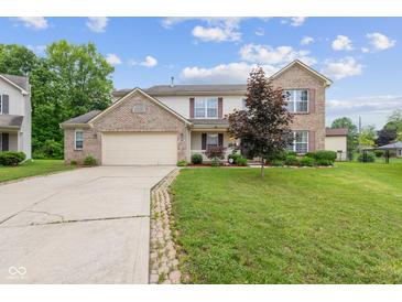 Charming two-story brick home featuring an attached two car garage and a well manicured front yard at 5852 Long Ridge Pl, Indianapolis, IN 46221