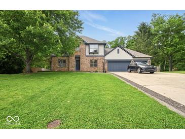 Charming two-story home with a brick facade, well-manicured lawn, and attached two-car garage at 6396 Granny Smith Ln, Avon, IN 46123