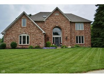 Charming two-story brick home with a well-manicured lawn and beautiful landscaping at 6862 Riverside Way, Fishers, IN 46038