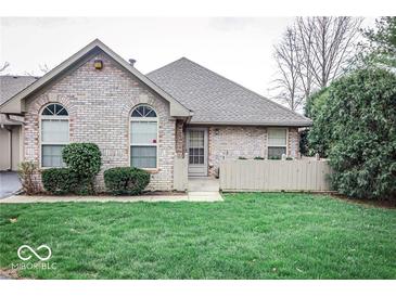 Charming brick home with well-maintained lawn and landscaping offering pleasant curb appeal at 7545 Briarstone Dr, Indianapolis, IN 46227