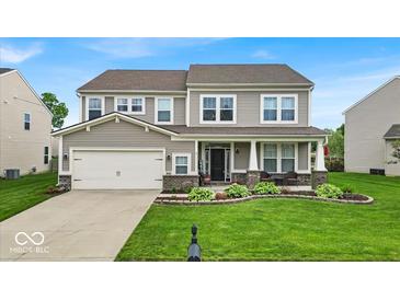 Charming two-story home with manicured lawn and inviting front porch at 10515 Sugar Ridge Way, Indianapolis, IN 46239