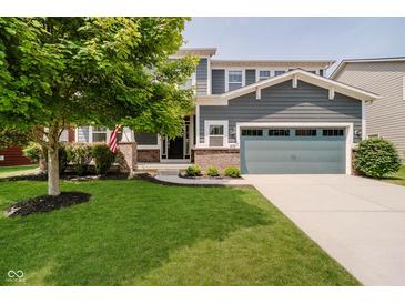 Charming two-story home with a well-maintained lawn and an attached two-car garage at 10962 Stoneleigh Dr, Noblesville, IN 46060