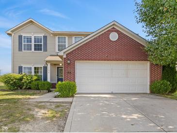 Charming two-story home featuring a two-car garage, well-maintained lawn, and inviting curb appeal at 11614 Gosling Dr, Indianapolis, IN 46229