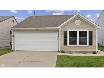 Charming home featuring a garage, well-manicured lawn, and a classic window design at 1313 Kenwood Dr, Greenwood, IN 46143