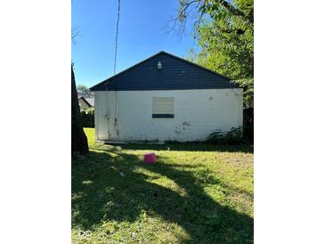 View of backyard garage of building shows blue painted roof with white siding on a sunny day at 1920 Kildare Ave, Indianapolis, IN 46218