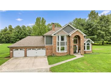Stunning brick and gray two-story home featuring a three-car garage and arched entry at 2871 Mullinix Rd, Greenwood, IN 46143