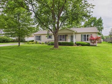 Charming ranch-style home with lush green lawn, mature trees, and well-maintained landscaping at 3004 N Timber Ln, Muncie, IN 47304