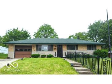 Charming one-story home features a well-maintained lawn and an attached one-car garage at 317 Grovewood Dr, Beech Grove, IN 46107