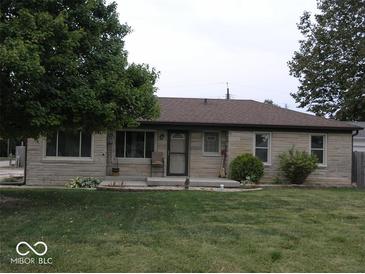 Charming ranch-style home with stone exterior, well-maintained lawn, and inviting front porch at 3456 S Sadlier S Dr, Indianapolis, IN 46239
