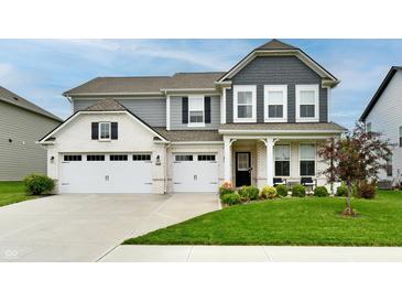 Beautiful two-story home with a manicured lawn, charming landscaping, and a three car garage at 3872 New Battle Ln, Bargersville, IN 46106