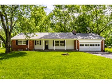 Charming single story brick home with an attached garage and a covered front porch at 4275 Springwood Trl, Indianapolis, IN 46228