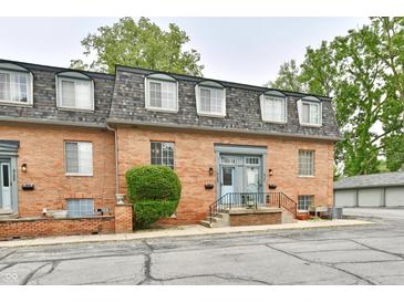 Charming brick two-story townhome with landscaped yard and a welcoming blue front door at 5153 Brendonshire Ct, Indianapolis, IN 46226