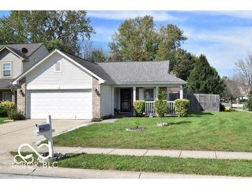 Charming single-story home featuring a well-maintained lawn and attached two-car garage at 5216 Lakeside Manor Blvd, Indianapolis, IN 46254