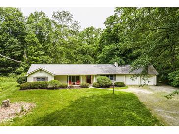 Charming ranch-style home with a well-manicured front yard and a welcoming red door at 5975 S 800 E, Zionsville, IN 46077