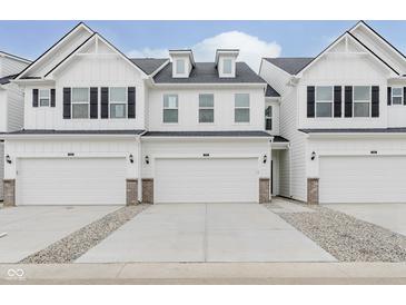 Charming white townhome with a two-car garage and beautifully designed exterior features at 7330 Shroyer Way, Noblesville, IN 46062