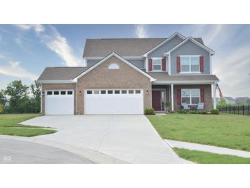 Charming two-story home boasts a brick and siding facade with a two-car garage and well-manicured lawn at 925 Bent Branch Cir, Greenwood, IN 46143