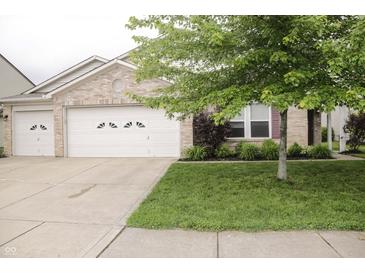 Charming brick home featuring a well-manicured lawn and a two-car garage, perfect for suburban living at 10112 Split Rock Way, Brownsburg, IN 46112