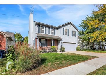Charming two-story home with light gray siding, green shutters, and a well-manicured lawn at 1024 Rotherham Ln, Beech Grove, IN 46107