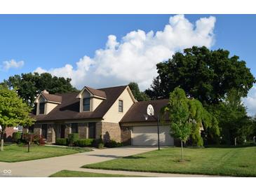 Charming two-story brick home with a well-maintained lawn, a basketball hoop, and mature trees at 1065 Lakewood South Dr, Brownsburg, IN 46112