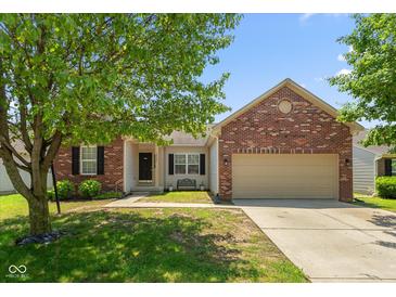 Charming single-Gathering home featuring a brick facade, attached garage, and a well-maintained front yard at 10725 Tedder Lake Dr, Indianapolis, IN 46239