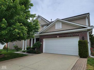 Two story house with brick accents and a two car garage is showcased in this exterior home image at 11070 Long Lake Ln, Fishers, IN 46037
