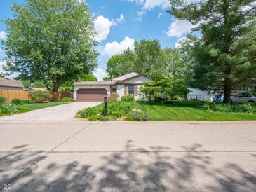 Charming single-story home with well-maintained lawn, beautiful landscaping and a two car garage at 1325 Countryside Ln, Indianapolis, IN 46231