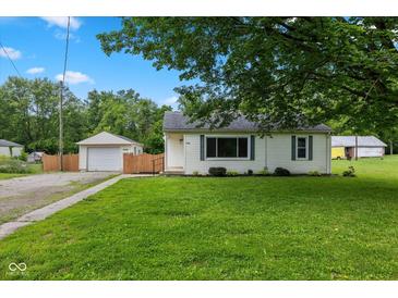 Charming single-story home with a well-maintained front yard, detached garage and ample green space at 1382 S Morgantown Rd, Greenwood, IN 46143