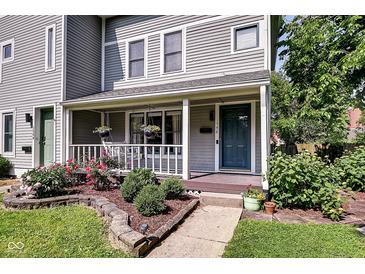 Charming home with a cozy porch, manicured landscaping, and inviting curb appeal at 1548 N Park Ave, Indianapolis, IN 46202