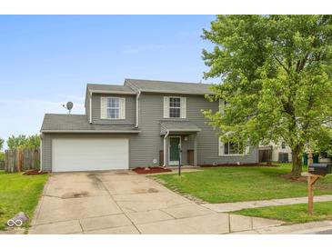 Charming two-story home with attached garage, well-kept lawn and mature trees at 2782 Branigin Creek Blvd, Franklin, IN 46131