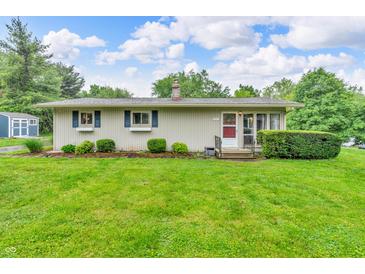 Charming ranch home featuring a well-manicured lawn and tidy landscaping at 3201 Chamberlin Dr, Indianapolis, IN 46227