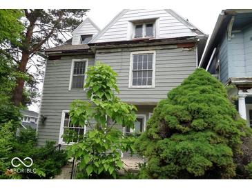 Two-story home with gray siding, white trim, and mature trees at 340 W 11Th St, Anderson, IN 46016