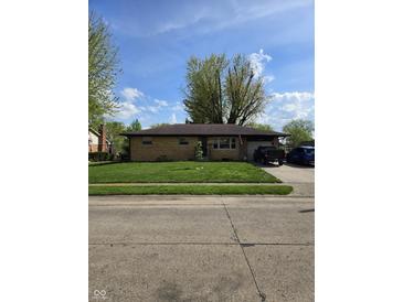 Charming brick home with a well-manicured lawn and driveway, perfect for suburban living at 6133 Ashway Ct, Indianapolis, IN 46224