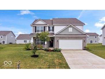 Charming two-story home with a well-manicured lawn and a two-car garage at 6507 W Whispering Way, Greenfield, IN 46140