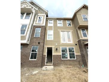 A beautiful new build townhome with brick and siding, and white trim on a cloudy day at 7317 Bayview Run, McCordsville, IN 46055