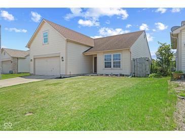 Charming home featuring a two-car garage, neat lawn and lovely curb appeal at 10693 Newgate Ln, Indianapolis, IN 46231