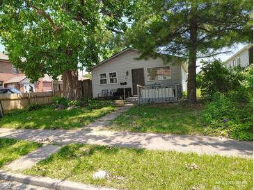Charming single-story home with a cozy front yard and mature trees providing ample shade at 239 N 6Th Ave, Beech Grove, IN 46107
